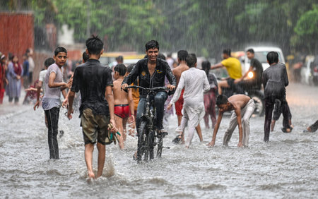 NEW DELHI, INDIA - JULY 27: Children play on a waterlogged Tagore Road stretch near Civic center Building after a brief spell of rain, on July 27, 2024 in New Delhi, India. (Photo by Raj K Raj/Hindustan Times )のeditorial素材