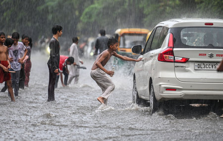 NEW DELHI, INDIA - JULY 27: Children play on a waterlogged Tagore Road stretch near Civic center Building after a brief spell of rain, on July 27, 2024 in New Delhi, India. (Photo by Raj K Raj/Hindustan Times )のeditorial素材