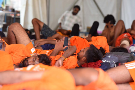 GURUGRAM, INDIA - JULY 27: Kanwariyas take rest in a Baba Mastnath Kawariya Seva shivir during Kanwar Yatra at National Highway-48 near Jharsa Chowk, on July 27, 2024 in Gurugram, India. The Kanwar Yatra is an annual pilgrimage of Lord Shiva's devotees. Dのeditorial素材