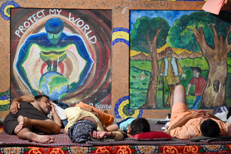 NOIDA, INDIA - JULY 29: Kanwariyas rest in a Kanwar Yatra camp built near Okhla Bird Sanctuary as they returning home after carrying holy water collected from River Ganga in Haridwar on July 29, 2024 in Noida, India. People will celebrate the Sawan Shivraのeditorial素材