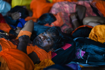 NOIDA, INDIA - JULY 29: Kanwariyas rest in a Kanwar Yatra camp built at Sector 14 A as they are returning home after carrying holy water collected from River Ganga in Haridwar on July 29, 2024 in Noida, India. People will celebrate the Sawan Shivratri on のeditorial素材