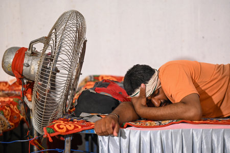 NOIDA, INDIA - JULY 29: Kanwariyas rest in a Kanwar Yatra camp built near Okhla Bird Sanctuary as they returning home after carrying holy water collected from River Ganga in Haridwar on July 29, 2024 in Noida, India. People will celebrate the Sawan Shivraのeditorial素材
