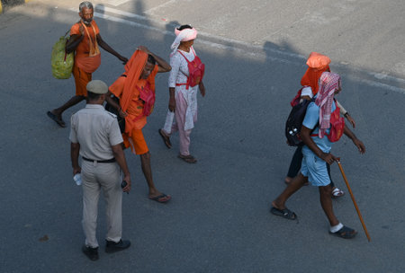 GURUGRAM, INDIA - JULY 29: Kanwariyas carrying holy water collected from River Ganga in Haridwar going back to their hometown during the Kanwar Yatra at National Highway-48 near Iffco Chowk on July 29, 2024 in Gurugram, India. People will celebrate the Saのeditorial素材