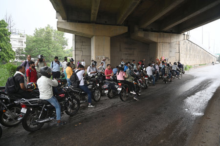 GURUGRAM, INDIA - JULY 31: Commuters are seen at National Highway-48 amid rain near IFFCO Chowk elevated flyover, on July 31, 2024 in Gurugram, India. (Photo by Parveen Kumar/Hindustan Times )のeditorial素材