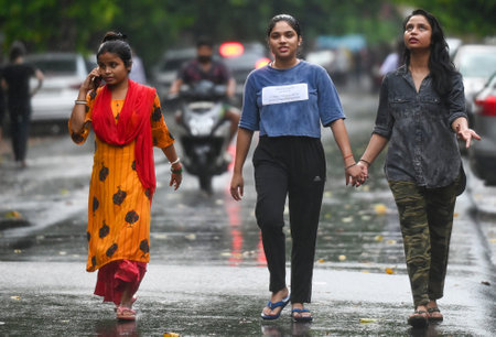 NOIDA, INDIA - AUGUST 4: Commuters step out during evening rain at sector 12, on August 4, 2024 in Noida, India. (Photo by Sunil Ghosh /Hindustan Times )のeditorial素材