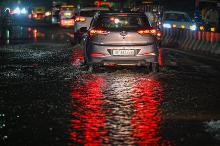 NOIDA, INDIA - AUGUST 10: Commuter pass through a heavily waterlogged stretch of road, at Sector 27 on Friday Night, on August 10, 2024 in Noida, India. (Photo by Sunil Ghosh/Hindustan Times )のeditorial素材