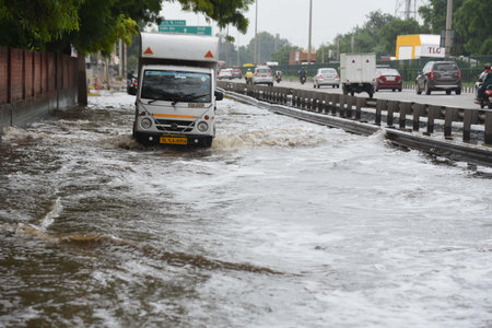 GURUGRAM, INDIA - AUGUST 10: Vehicles wade through a waterlogged stretch after the rain at National...