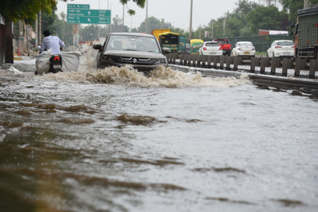 GURUGRAM, INDIA - AUGUST 10: Vehicles wade through a waterlogged stretch after the rain at National...