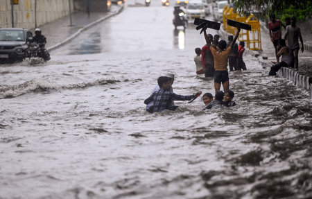 NEW DELHI, INDIA - AUGUST 11: Children are playing in waterlogged stretch at NH 24, near Mayur Vihar, on August 11, 2024 in New Delhi, India. (Photo by Ajay Aggarwal/Hindustan Times )のeditorial素材