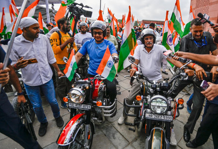 NEW DELHI, INDIA - AUGUST 13: Union Ministers Kiren Rijiju and Gajendra Singh Shekhawat ride bikes during the Har Ghar Tiranga Bike Rally flagged off by Vice President Jagdeep Dhankhar ahead of the 78th Independence Day, at Bharat Mandapam on August 13, 2のeditorial素材