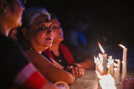 NOIDA, INDIA - AUGUST 15: Members of the Noida Bengali Cultural Association (NBCA) staged a candlelight protest at Noida Kali Bari Sector 26 on Wednesday night against the alleged sexual assault and murder of an intern doctor at Kolkata's RG Kar Medical Cのeditorial素材