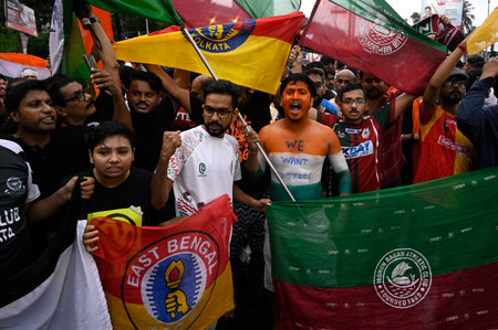 KOLKATA, INDIA - AUGUST 18: Football fans of two main club Mohun Bagan SG, East Bengal FC stage...