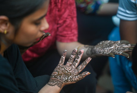 NOIDA, INDIA - AUGUST 18: Girls get Mahendi applied on her hands on the eve of Raksha Bandhan...