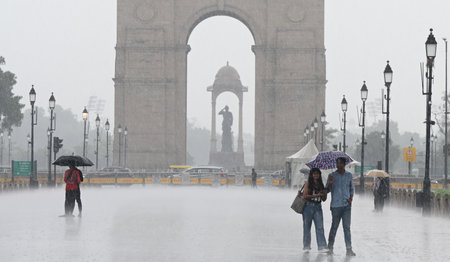 NEW DELHI, INDIA - AUGUST 18: People enjoying during sudden rainfall at Kartavya Path, on August 18,...
