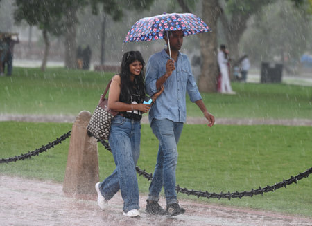NEW DELHI, INDIA - AUGUST 18: People enjoying during sudden rainfall at Kartavya Path, on August 18, 2024 in New Delhi, India. (Photo by Sonu Mehta/Hindustan Times )のeditorial素材