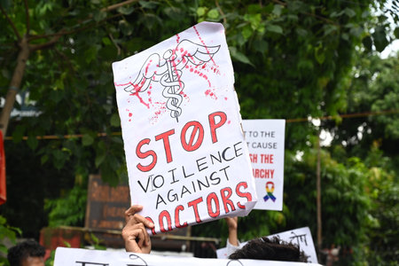 NEW DELHI, INDIA - AUGUST 21: Practicing doctors and medical staff display placards as they take part in a protest against the incident of rape and murder of a young medic in Kolkata, during a demonstration held at Jantar Mantar  on August 21, 2024 in Newのeditorial素材