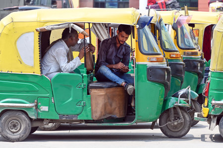 NEW DELHI, INDIA - AUGUST 22: Taxis and auto rickshaws stand parked outside New Delhi Railway...
