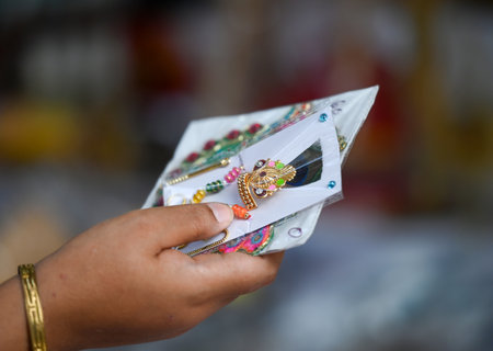 NOIDA, INDIA - AUGUST 25: Devotees buying idols of Lord Krishna and his costumes on the eve of...