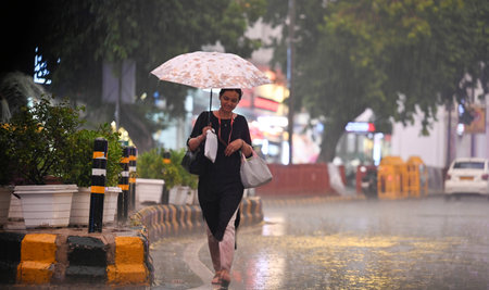 NEW DELHI, INDIA - SEPTEMBER 5 2024  People walking under the dark Cloud during the heavy Rain at Connaught place, on September 5, 2024 in New Delhi, India. (Photo by Raj K Raj/Hindustan Times )のeditorial素材