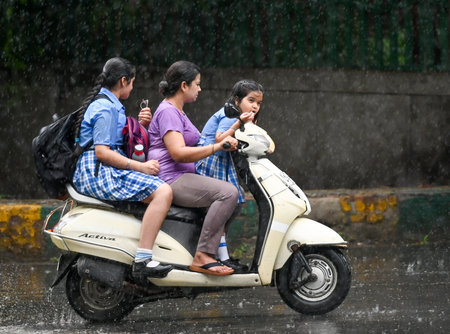 NOIDA, INDIA - SEPTEMBER 4 2024  Commuters step out during afternoon rain at sector 37, on September 4, 2024 in Noida, India. Delhi-NCR residents witnessed a sudden change in weather as heavy rain lashed several parts of the city. (Photo by Sunil Ghosh/Hiのeditorial素材