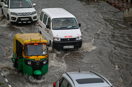 NEW DELHI, INDIA - SEPTEMBER 4 2024  Commuters wade through a waterlogged stretch at NH24 near Vinod Nagar, on September 4, 2024 in New Delhi, India. Delhi residents witnessed a sudden change in weather as heavy rain lashed several parts of the city. (Phoのeditorial素材
