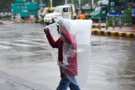 GURUGRAM, INDIA - SEPTEMBER 7: People seen amid light rainfall at NH-48 near Hero Honda chowk, on September 7, 2024 in Gurugram, India. (Photo by Parveen Kumar/Hindustan Times )のeditorial素材