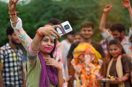 NOIDA INDIA SEPTEMBER 11 2024 Devotees gather at the Yamuna River during the immersion ceremony on...