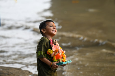 NOIDA INDIA SEPTEMBER 17 2024 On the last day of Ganpati Visarjan devotees gather on the banks of...