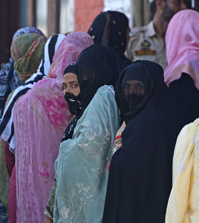 SRINAGARINDIA SEPTEMBER 18 2024 Voters queue to cast their votes at a polling station during the...