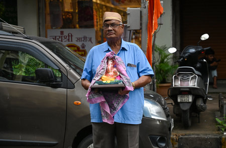 MUMBAI INDIA SEPTEMBER 6 2024 Devotees transport an idol of elephant headed Hindu god Ganesha from a...