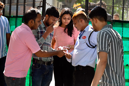 NEW DELHI, INDIA - SEPTEMBER 27: Security officials check the identity cards of Students before...