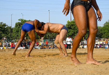 NOIDA, INDIA - OCTOBER 2: Wrestler plays Indian freestyle wrestling match on mud ground during a tournament match organized by local villagers in Sector 69, on October 2, 2024 in Noida, India. (Photo by Sunil Ghosh/Hindustan Times )のeditorial素材