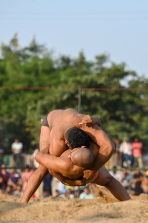 NOIDA, INDIA - OCTOBER 2: Wrestler plays Indian freestyle wrestling match on mud ground during a tournament match organized by local villagers in Sector 69, on October 2, 2024 in Noida, India. (Photo by Sunil Ghosh/Hindustan Times )のeditorial素材