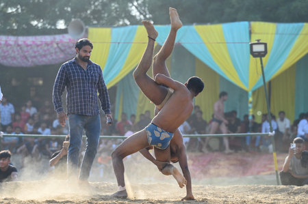 NOIDA, INDIA - OCTOBER 2: Wrestler plays Indian freestyle wrestling match on mud ground during a tournament match organized by local villagers in Sector 69, on October 2, 2024 in Noida, India. (Photo by Sunil Ghosh/Hindustan Times )のeditorial素材