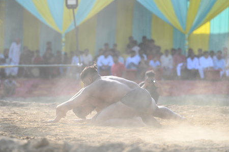 NOIDA, INDIA - OCTOBER 2: Wrestler plays Indian freestyle wrestling match on mud ground during a tournament match organized by local villagers in Sector 69, on October 2, 2024 in Noida, India. (Photo by Sunil Ghosh/Hindustan Times )のeditorial素材