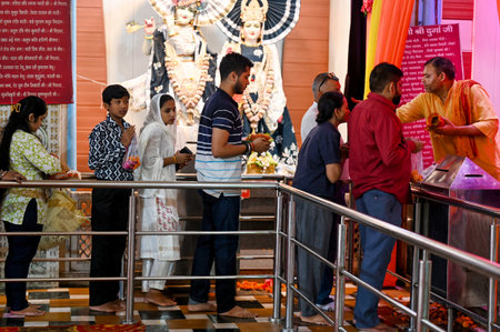 NOIDA INDIA OCTOBER 3 2024 Devotees offer prayers on the first day of Shardiya Navratri festival at Sanatan Dharm Mandir Sector 19 on October 3 2024 in Noida India Every year Sharadiya Navratri begins on the Prati pada date of Shukla Paksha of Ashwin montのeditorial素材