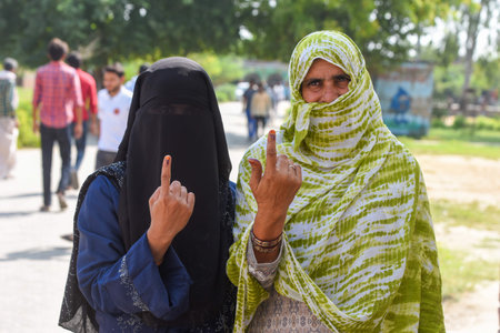 GURUGRAM, INDIA - OCTOBER 5: 5Womens showing their inked finger after cast her vote for Haryana Assembly Election at Gashera village in Nuh, Mewat, on October 5, 2024 in Gurugram, India. A total of 1,031 candidates are contesting in all 90 assembly constiのeditorial素材