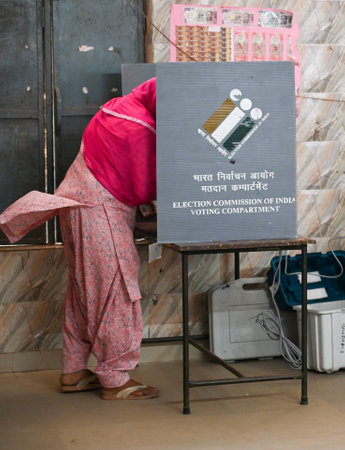 GURUGRAM, INDIA - OCTOBER 5: A woman cast her ballot at a polling station during the Haryana...