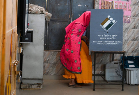 GURUGRAM, INDIA - OCTOBER 5: A woman cast her ballot at a polling station during the Haryana...