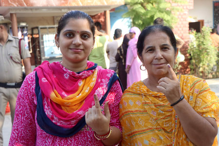 ROHTAK, INDIA - OCTOBER 5: Voters in Rohtak Assembly Constituency waiting in queue for their turn to exercise their franchise in General Election to Assembly, on October 5, 2024 in Rohtak, India. A total of 1,031 candidates are contesting in all 90 assembのeditorial素材