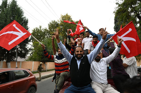 SRINAGAR, INDIA - OCTOBER 8: Supporters of National Conference (NC) celebrate outside the counting center on October 8, 2024 in Srinagar, India. National Conference Congress alliance has achieved victory in the Assembly polls, winning a total of 48 seats.のeditorial素材