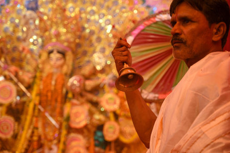 GURUGRAM, INDIA - OCTOBER 10: A Hindu Purohit offers prayer to Goddess Durga during the Durga Puja...