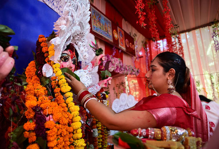 CHANDIGARH, INDIA - OCTOBER 13: Women offer prayers on the final day of the Durga Puja on the...