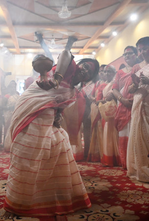 NOIDA, INDIA - OCTOBER 13: Devotees perform Dhunuchi dance offer prayer to Goddess Durga during the...