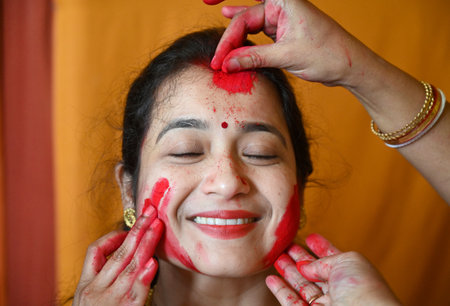 NOIDA, INDIA - OCTOBER 13: Women apply sindoor or vermilion on each other's faces during Sindoor Khela on the final day of the Durga Puja at Kali Bari Mandir Sector 26, on October 13, 2024 in Noida, India. (Photo by Sunil Ghosh/Hindustan Times )のeditorial素材