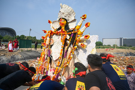 NOIDA, INDIA - OCTOBER 13: Devotees immerse the idol of Goddess Durga in an artificial pit on the...