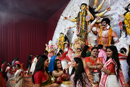 NEW DELHI, INDIA - OCTOBER 13: Devotees participate during Sindoor Khela on the last day of Durga Puja proceed with immersion of Lord Durga Maa, at CR Park, on October 13, 2024 in New Delhi, India. (Photo by Salman Ali/Hindustan Times )のeditorial素材