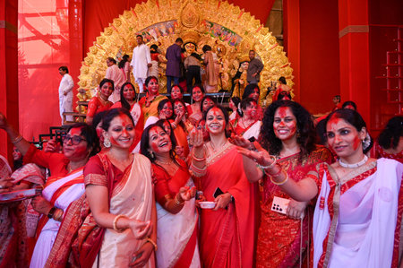 GURUGRAM, INDIA - OCTOBER 13: Bengali married women apply vermilion on each other as they...