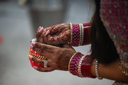 NOIDA, INDIA - OCTOBER 20: Hindu married women perform rituals on the occasion of Karva Chauth, at...