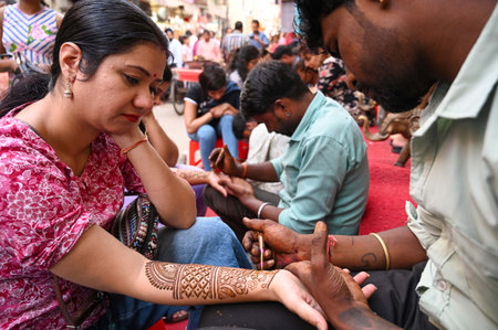 GURUGRAM, INDIA - OCTOBER 19: A woman applies 'henna' on her hands on the eve of 'Karva Chauth' festival in Sadar Bazar near Government Girls Senior Secondary School, Jacobpura, on October 19, 2024 in Gurugram, India. Karva Chauth is a one-day festival ceのeditorial素材